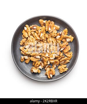 Peeled walnut kernels on plate isolated on white background. Stock Photo