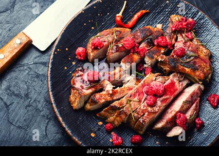 Fried steak with raspberry sauce Stock Photo