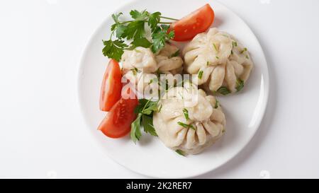 Georgian dumplings Khinkali with meat and red pepper, Traditional National Georgian cuisine. Stock Photo