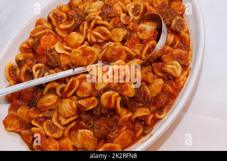South italian pasta orecchiette with tomato sauce and minced meat ragu Stock Photo