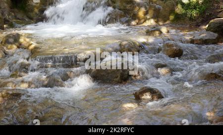 White water Mountain stream and Waterfall  mountain stream with rocks. Water rushes down over rocks and boulders in this mountain stream Stock Photo