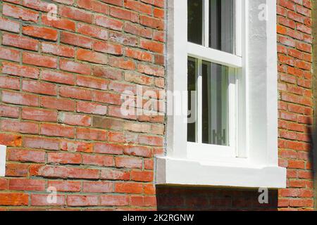Brick outer wall and white window Stock Photo
