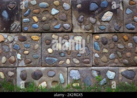 fieldstone wall concrete natural stone rock masonry stonewall background Stock Photo