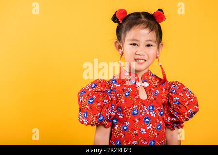 Happy Asian Chinese little girl smile wearing red cheongsam Stock Photo