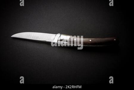 Traditional wooden pocket knife on black background Stock Photo