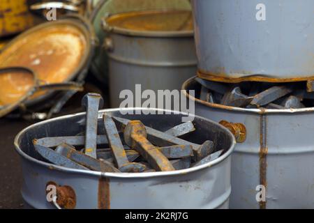 large nails for railroad track fix metal objects paint cans rust steel objects Stock Photo