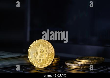 Bitcoin coins on keyboard computer with black background Stock Photo