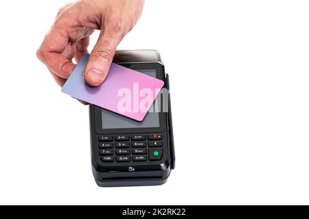 Attached plastic card to the payment terminal with a man's hand on a white isolated background, copy space Stock Photo