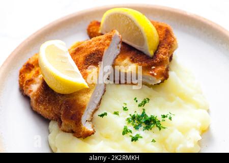 chicken schnitzel with mashed potatoes and lemon Stock Photo