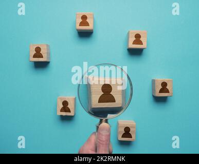 Man with magnifying glass searches for the ideal employee Stock Photo