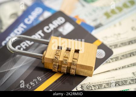 Credit card with password key lock security on US dollar background. Stock Photo