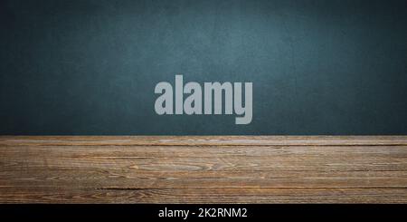 The background is blank wooden boards and a textured plastered wall with lighting and vignetting. Stock Photo