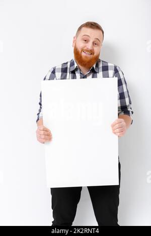 man with beard holding big white card. Stock Photo