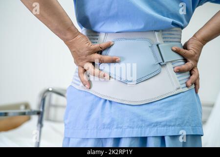 https://l450v.alamy.com/450v/2k2rp1y/asian-lady-patient-wearing-back-pain-support-belt-for-orthopedic-lumbar-with-walker-2k2rp1y.jpg