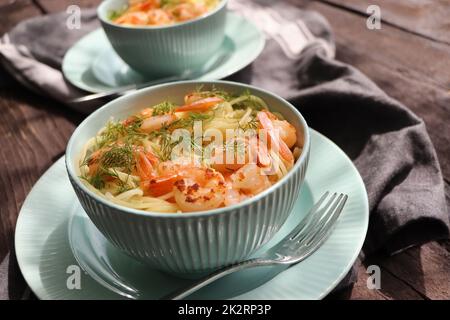 A plate of delicious shrimp alfredo with garlic and cream sauce over pasta Stock Photo