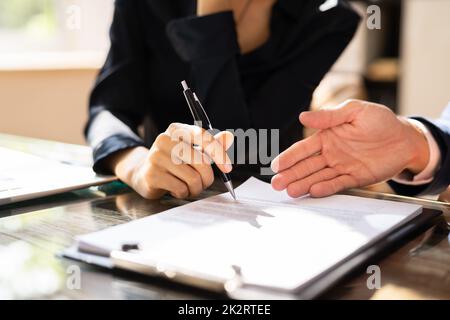 Two Businesspeople Analyzing Document Stock Photo