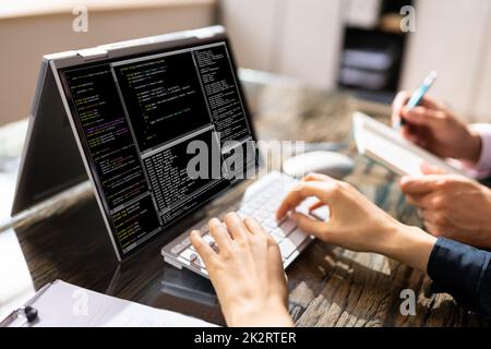 African American Coder Using Computer At Desk Stock Photo