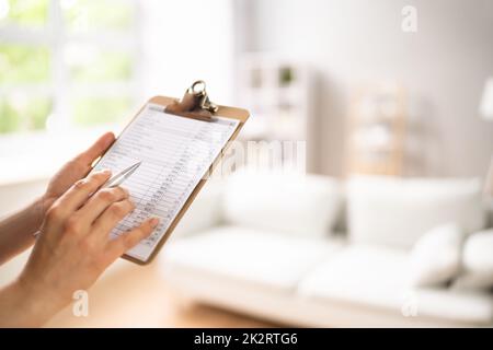 Woman Filling Real Estate Appraisal Form Stock Photo