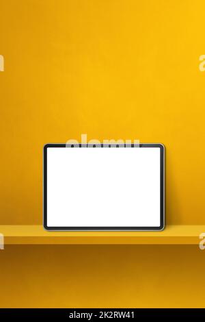 Digital tablet pc on yellow wall shelf. Vertical background banner Stock Photo