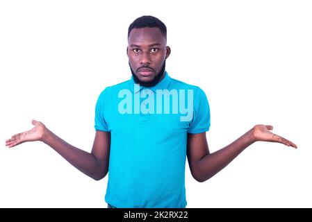 young man wearing a blue t-shirt, with a confused expression raising his arms and hands. Stock Photo