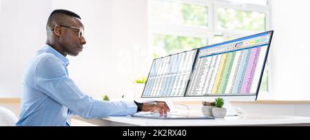 Data Analyst African Man Using Spreadsheet Stock Photo
