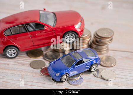 Car on stack of coins. Car loan, Finance, saving money, insurance and leasing time concepts. Stock Photo