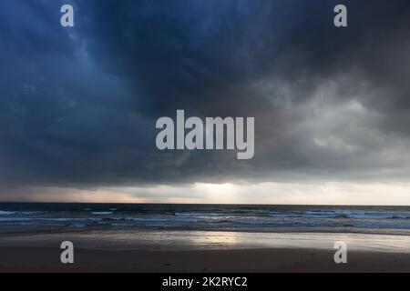 Gathering storm on beach Stock Photo