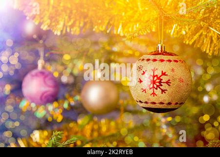 Christmas-tree decoration bauble on decorated Christmas tree bac Stock Photo