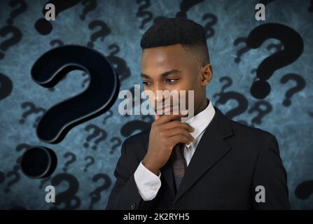 pensive young man thinking doubt expression question mark background Stock Photo