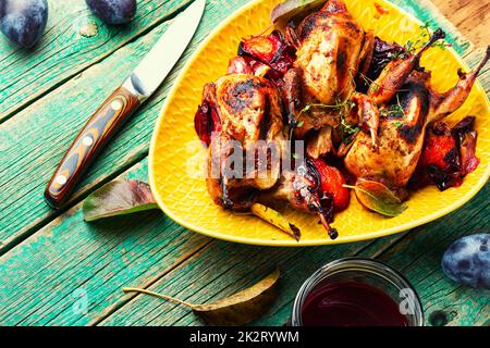 Quail stuffed with plums. Stock Photo