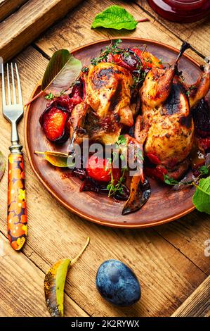 Quail stuffed with plums. Stock Photo