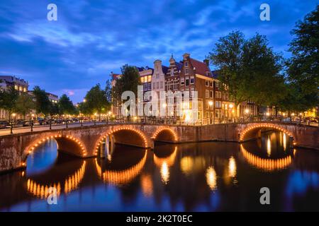 Amterdam canal, bridge and medieval houses in the evening Stock Photo