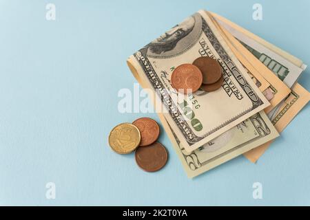 Multicurrency banknotes, euro coins, dollars on a blue background. The concept of the world economy during the crisis. Stock Photo