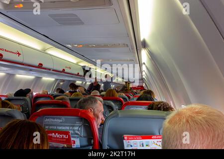 Passengers on board a Jet 2 Boeing 737 aircraft shortly after take off from Manchester Airport in northern England UK Stock Photo