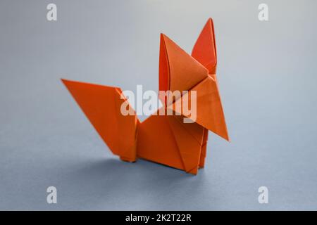 Orange paper fox origami isolated on a grey background Stock Photo