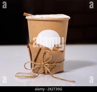 Biodegradable Disposable Cup with blank white circle for text containing a hot drink with copy space. Stock Photo