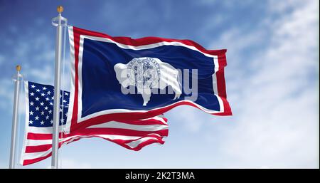 The Wyoming state flag waving along with the national flag of the United States of America Stock Photo