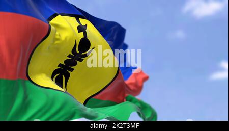 The flag of New Caledonia waving in the wind on a clear day Stock Photo