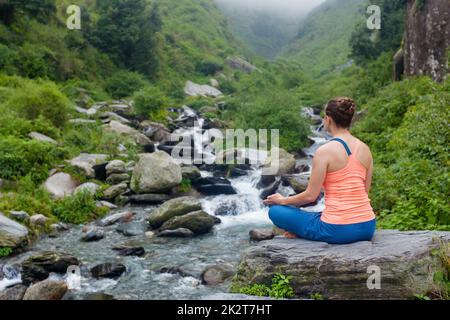 Woman doing yoga outdoors Stock Photo
