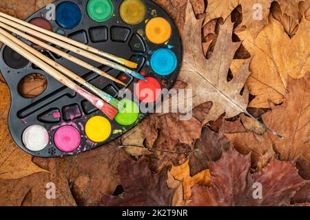 Watercolor paints on the autumn leaves Stock Photo - Alamy