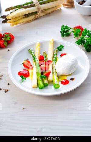 Burrata cheese with asparagus and strawberries Stock Photo