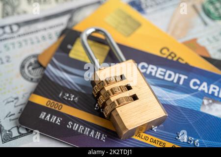 Credit card with password key lock security on US dollar background. Stock Photo