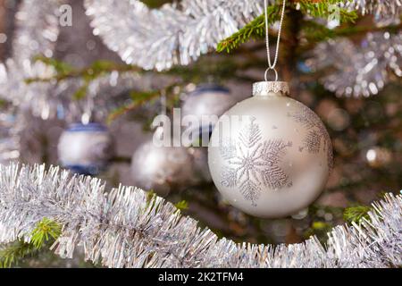 Decoration bauble on decorated Christmas tree Stock Photo