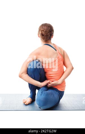 Woman doing Ashtanga Vinyasa Yoga asana Marichyasana D Stock Photo