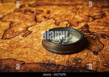 Old vintage compass on ancient map Stock Photo