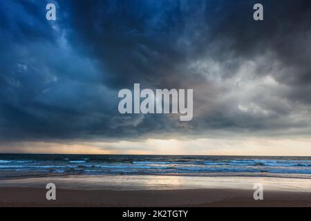 Gathering storm on beach Stock Photo