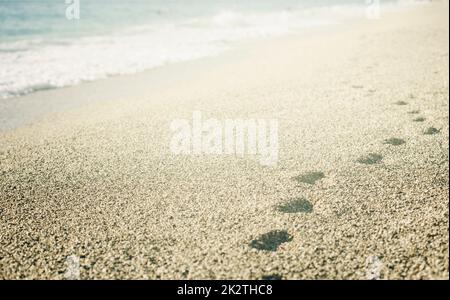 Footprints on the beach Stock Photo