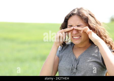 Woman scratching eyes in a wheat field Stock Photo
