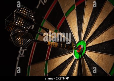 Three darts in bull's eye close up Stock Photo