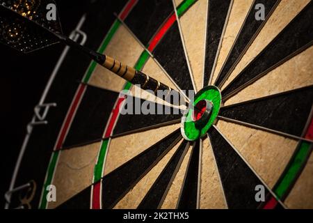 Dart in bull's eye close up Stock Photo
